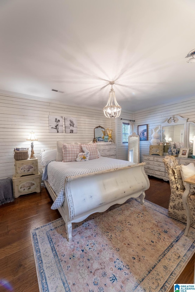 bedroom with wood finished floors and visible vents