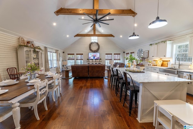 kitchen featuring a wealth of natural light, dark wood-style floors, dishwasher, and open floor plan