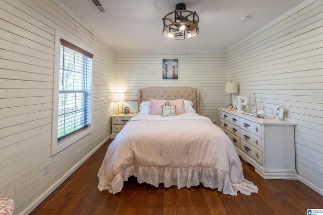 bedroom with visible vents, baseboards, and dark wood-style flooring