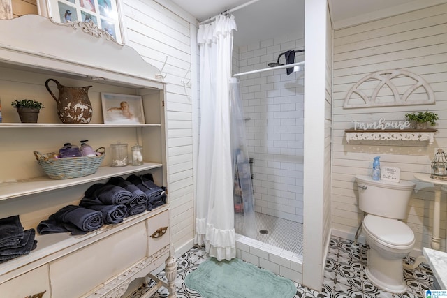 full bathroom with tile patterned floors, toilet, and a stall shower