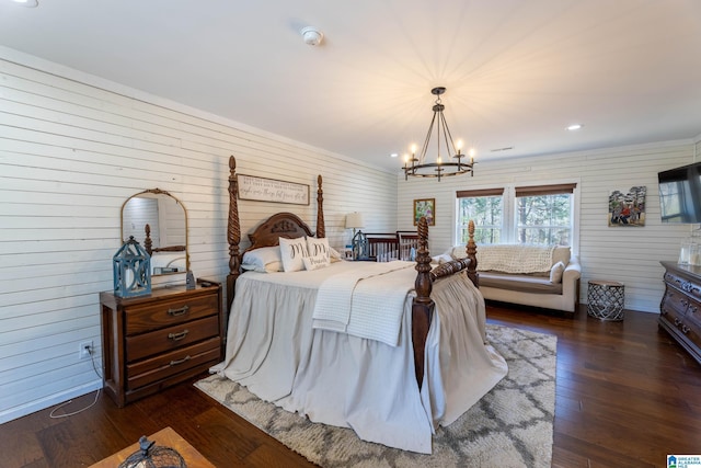 bedroom featuring dark wood-style floors, recessed lighting, and an inviting chandelier