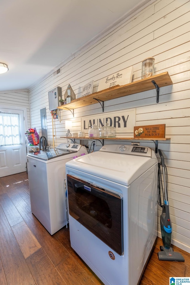 laundry area featuring laundry area, wood-type flooring, and washing machine and clothes dryer