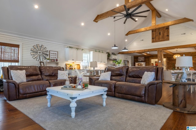 living room with beamed ceiling, high vaulted ceiling, wooden walls, and hardwood / wood-style floors