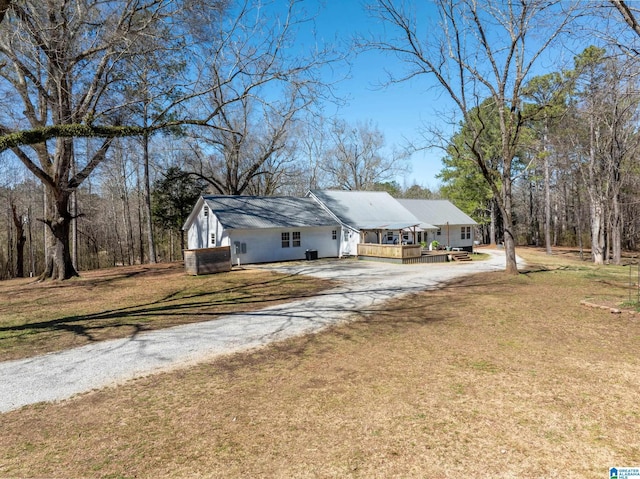 single story home featuring a front lawn, covered porch, and driveway