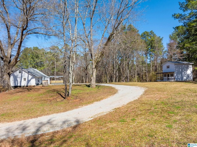 view of yard with dirt driveway