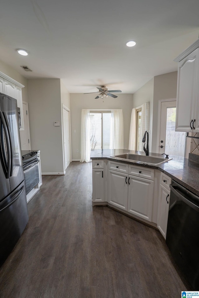 kitchen featuring a healthy amount of sunlight, electric range, freestanding refrigerator, a sink, and dishwasher