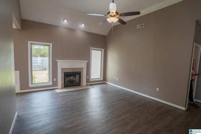 unfurnished living room with visible vents, dark wood-type flooring, a ceiling fan, a fireplace, and baseboards