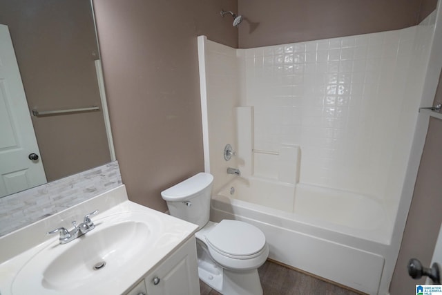 full bath featuring shower / bath combination, toilet, vanity, and wood finished floors