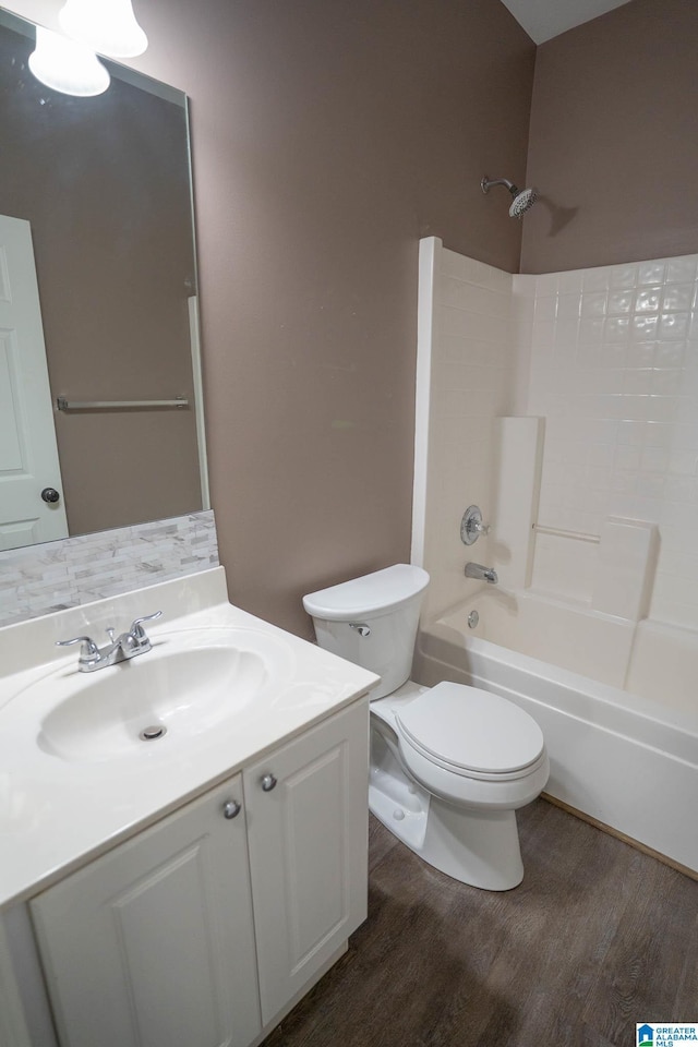 full bathroom with vanity, toilet, wood finished floors, and shower / bathtub combination