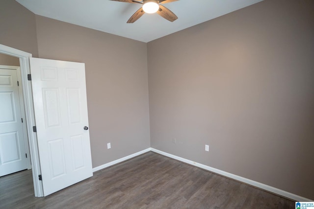 spare room with a ceiling fan, wood finished floors, and baseboards