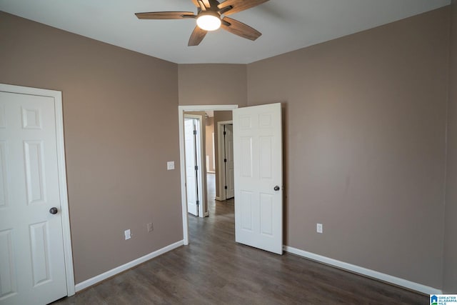 unfurnished bedroom featuring a ceiling fan, baseboards, and dark wood-style flooring