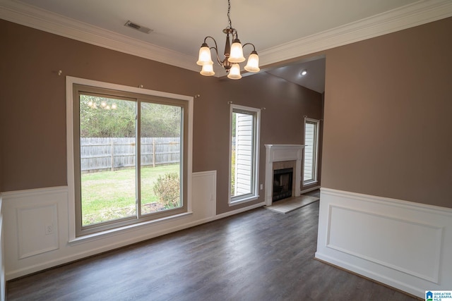 unfurnished living room featuring a fireplace, visible vents, and wainscoting