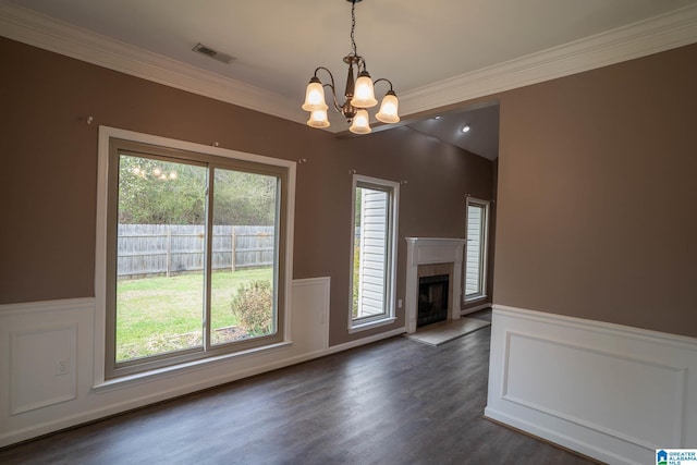 unfurnished living room with visible vents, a tile fireplace, and a wainscoted wall