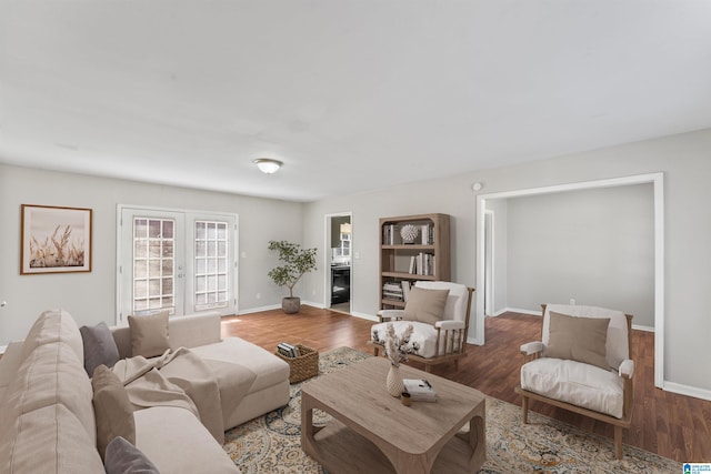 living room with french doors, wood finished floors, and a fireplace