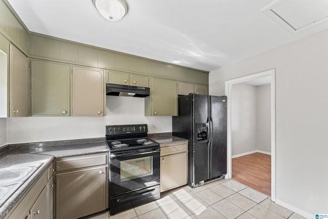 kitchen with under cabinet range hood, dark countertops, black appliances, and light tile patterned floors