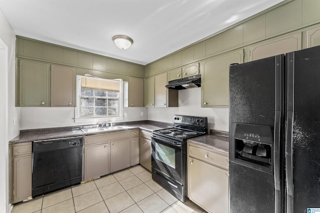 kitchen featuring black appliances, under cabinet range hood, a sink, dark countertops, and light tile patterned floors