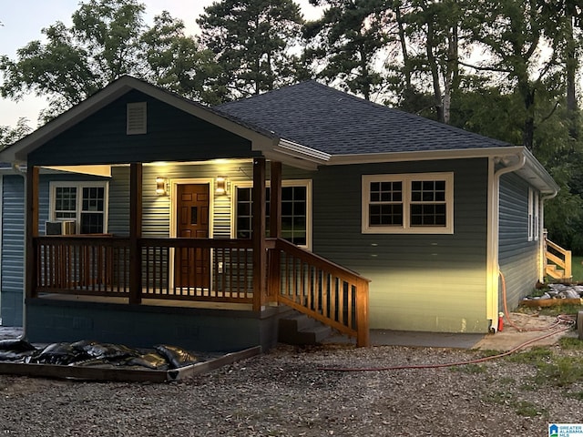 bungalow featuring crawl space, roof with shingles, and a porch