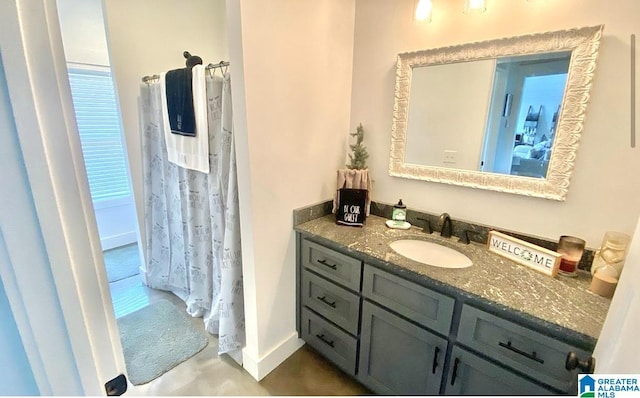 bathroom featuring vanity and baseboards