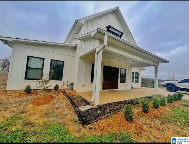 back of house with a patio, french doors, and board and batten siding