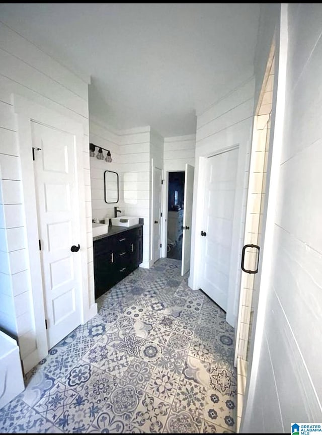 full bathroom with vanity, tile walls, and a stall shower