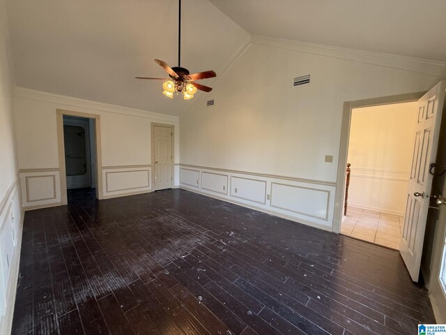 unfurnished room with vaulted ceiling, wood finished floors, and visible vents