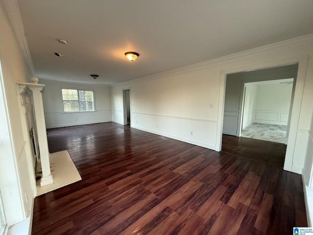 unfurnished room featuring a high end fireplace, baseboards, dark wood-style flooring, and crown molding