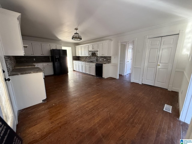 kitchen with visible vents, dark wood-type flooring, black appliances, a sink, and backsplash