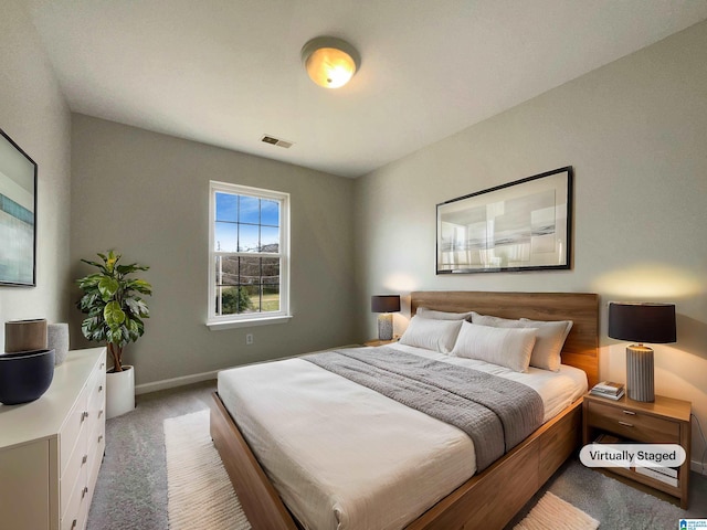 bedroom featuring light colored carpet, visible vents, and baseboards