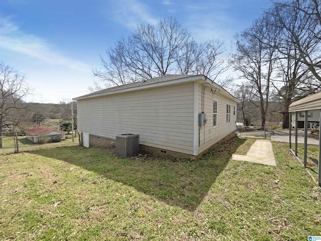 view of side of home featuring crawl space, a lawn, central AC, and fence