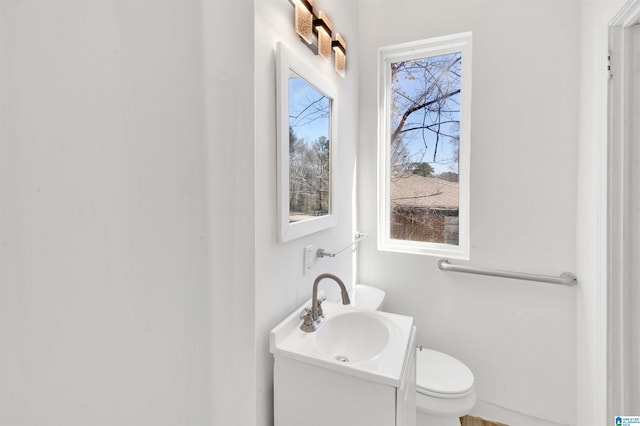 bathroom featuring toilet and vanity