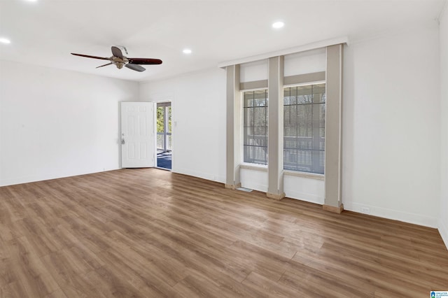 empty room featuring recessed lighting, ceiling fan, baseboards, and wood finished floors