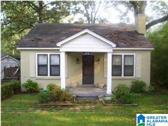 bungalow-style home featuring a porch and a front lawn