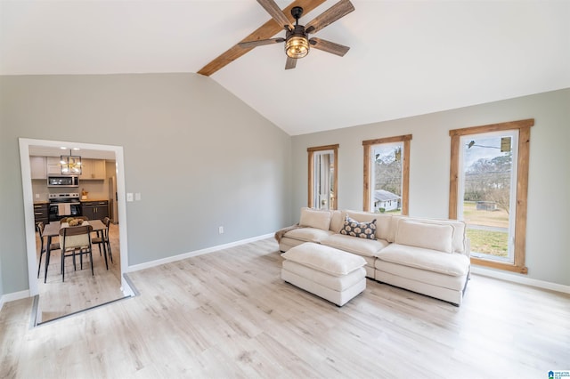 living area featuring baseboards, light wood-style flooring, vaulted ceiling with beams, and ceiling fan with notable chandelier