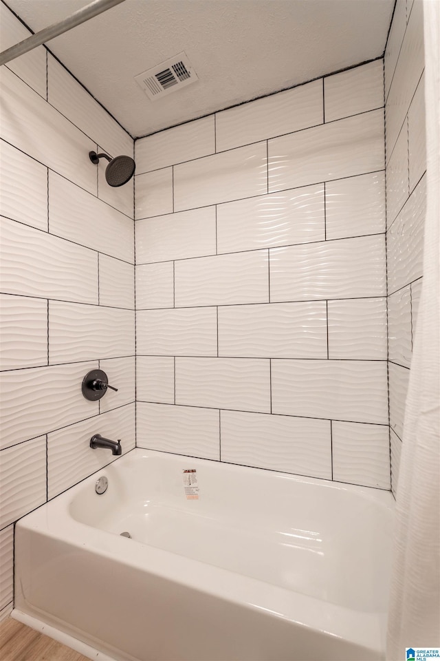 full bath with visible vents and shower / bathtub combination with curtain