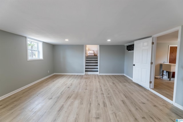 interior space with light wood finished floors, stairway, recessed lighting, and baseboards