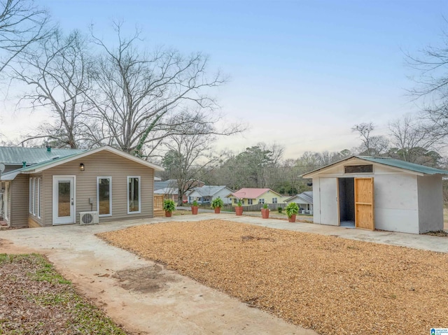 view of yard featuring ac unit, an outdoor structure, and a shed