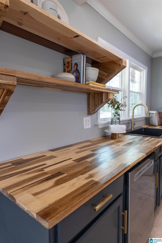 bar with dishwasher, ornamental molding, and a sink