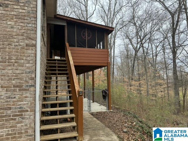 exterior space with brick siding and a gate