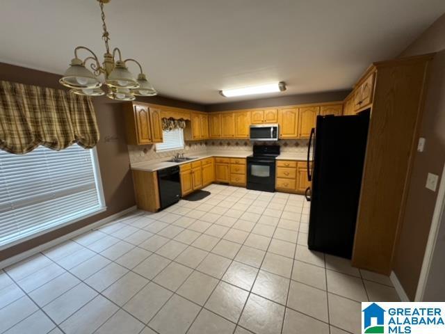 kitchen with black appliances, a sink, backsplash, light countertops, and light tile patterned floors