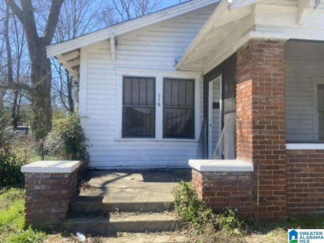 view of side of home featuring brick siding