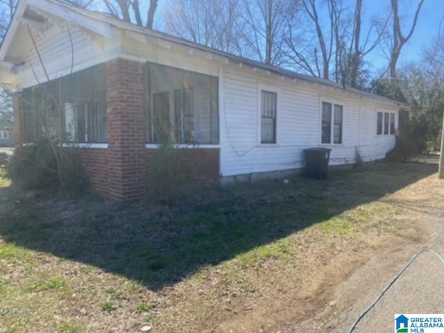 view of side of home featuring brick siding