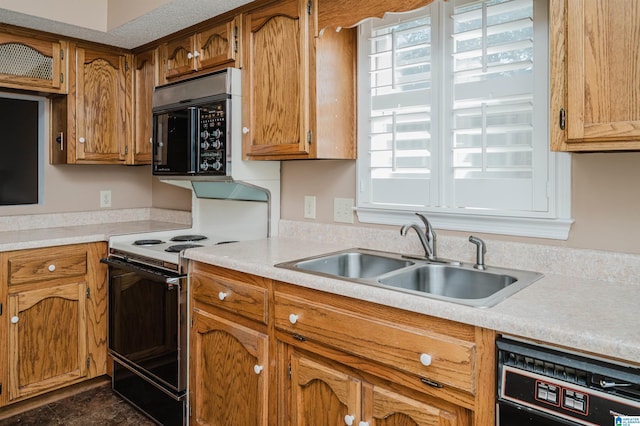 kitchen featuring black microwave, light countertops, dishwashing machine, range with electric stovetop, and a sink