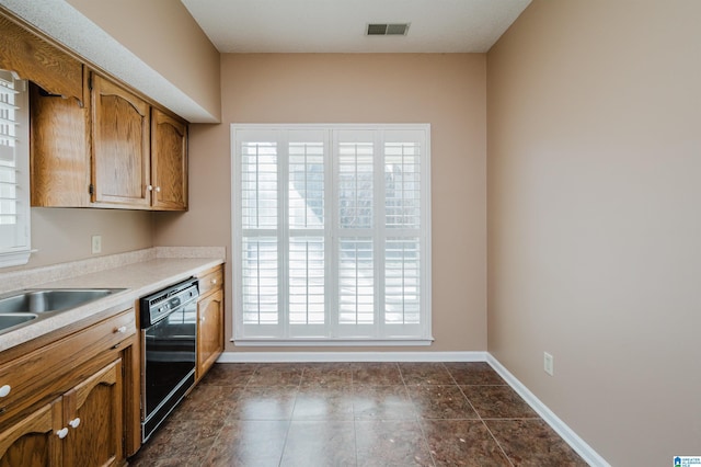 kitchen with dishwasher, baseboards, visible vents, and a wealth of natural light