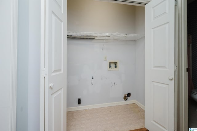 washroom featuring washer hookup, laundry area, light floors, and baseboards