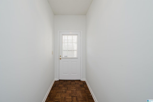 doorway to outside with baseboards