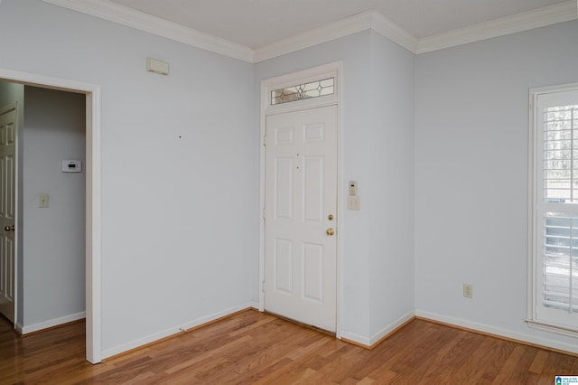 entrance foyer with baseboards, light wood-style flooring, and ornamental molding