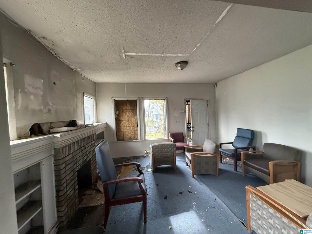 interior space featuring a fireplace, concrete floors, and a textured ceiling