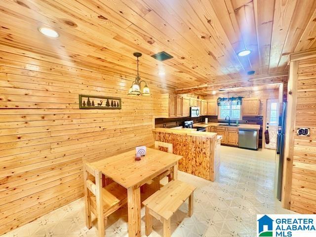 dining space with recessed lighting, wood walls, light floors, wood ceiling, and a chandelier