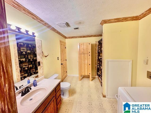 full bathroom with tile patterned floors, visible vents, a textured ceiling, crown molding, and vanity