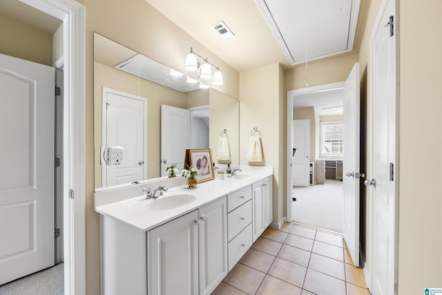 full bathroom with tile patterned flooring, double vanity, visible vents, and a sink